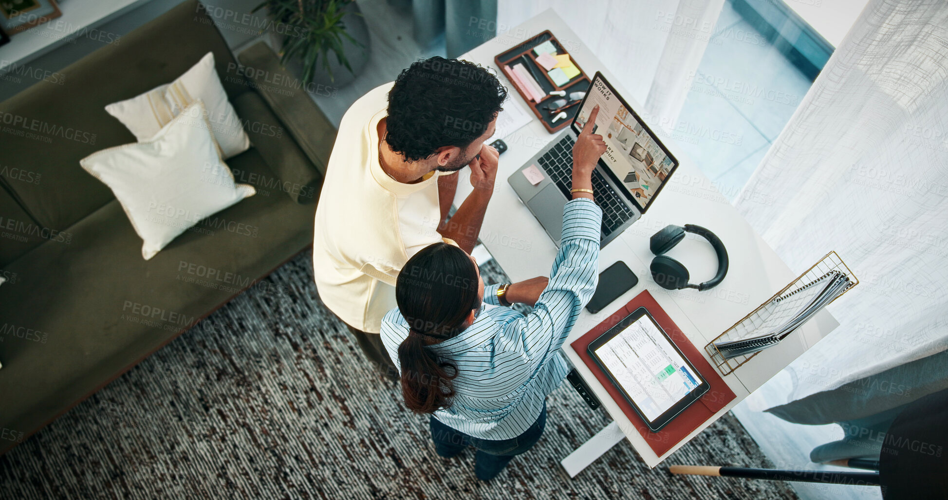 Buy stock photo Couple, talk and people with laptop in home office, video editing and planning for submission on web. Above, man and woman with tech for content creation, pointing and remote work with standing desk