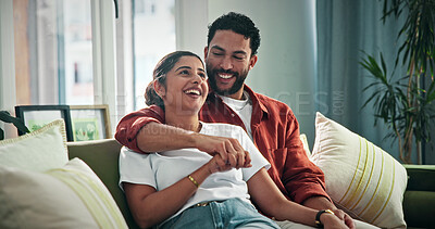 Buy stock photo Laugh, relax and couple holding hands on sofa for bonding, funny conversation and healthy marriage. Security, happy people and hug in home with comic discussion, weekend break and relationship trust