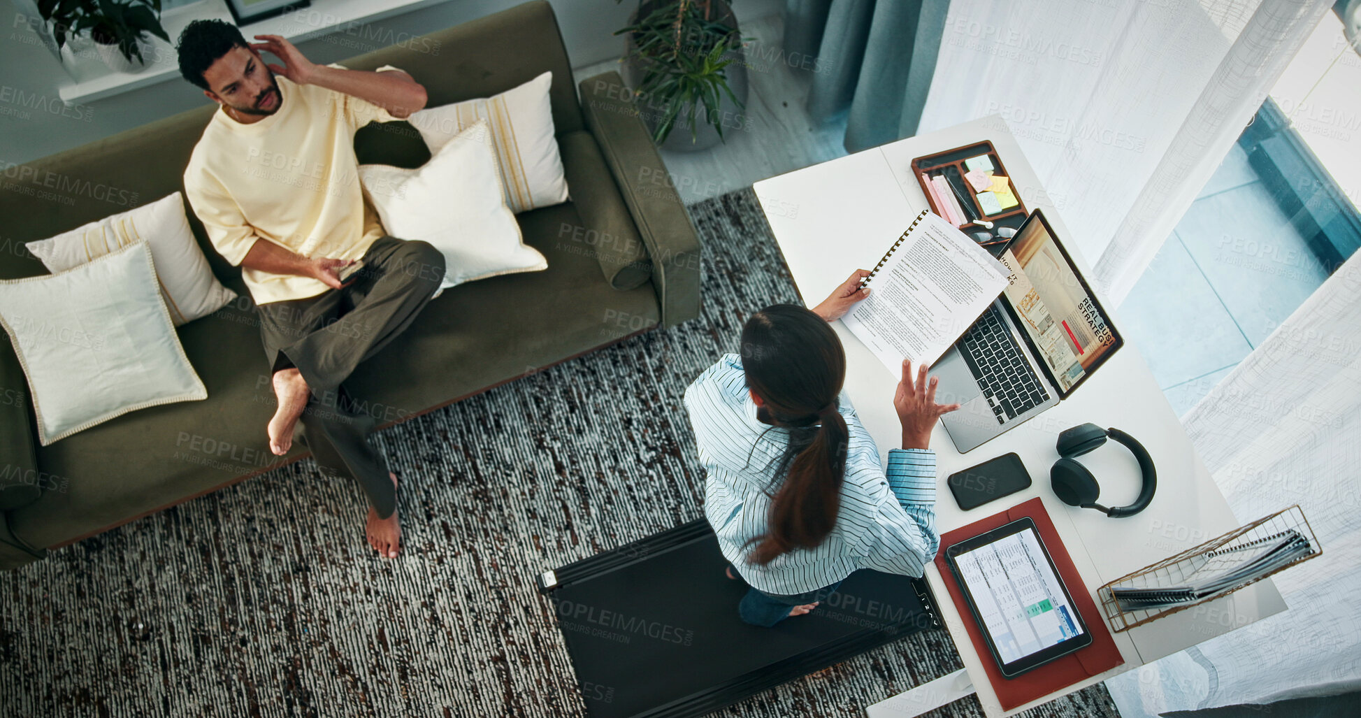 Buy stock photo Woman, multitask and laptop for remote work from home man, discussion and above in living room. People, freelance job and conversation with relationship, smartphone and documents for project at house