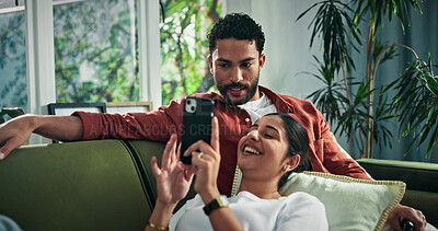 Buy stock photo Happy, talking and couple on sofa with phone for social media, networking and bonding on weekend. Marriage, relax and man with woman on smartphone for internet, website and connection in home