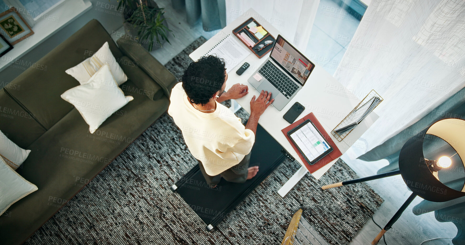 Buy stock photo Walking, treadmill and man with laptop in office, exercise or multitasking for design ideas in home. Fitness, graphic designer and person with standing desk for remote work, above and research on web