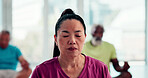 Calm, woman and meditation with class for spiritual wellness, healing or inner peace in studio. Female person, relax or instructor with breathing exercise for mindfulness, stress relief or balance