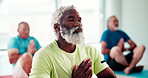 Prayer hands, meditation and senior man in studio with breathing exercise for wellness, calm or zen. Relax, lotus pose and group of elderly male person at yoga class for health, mindfulness or heal.