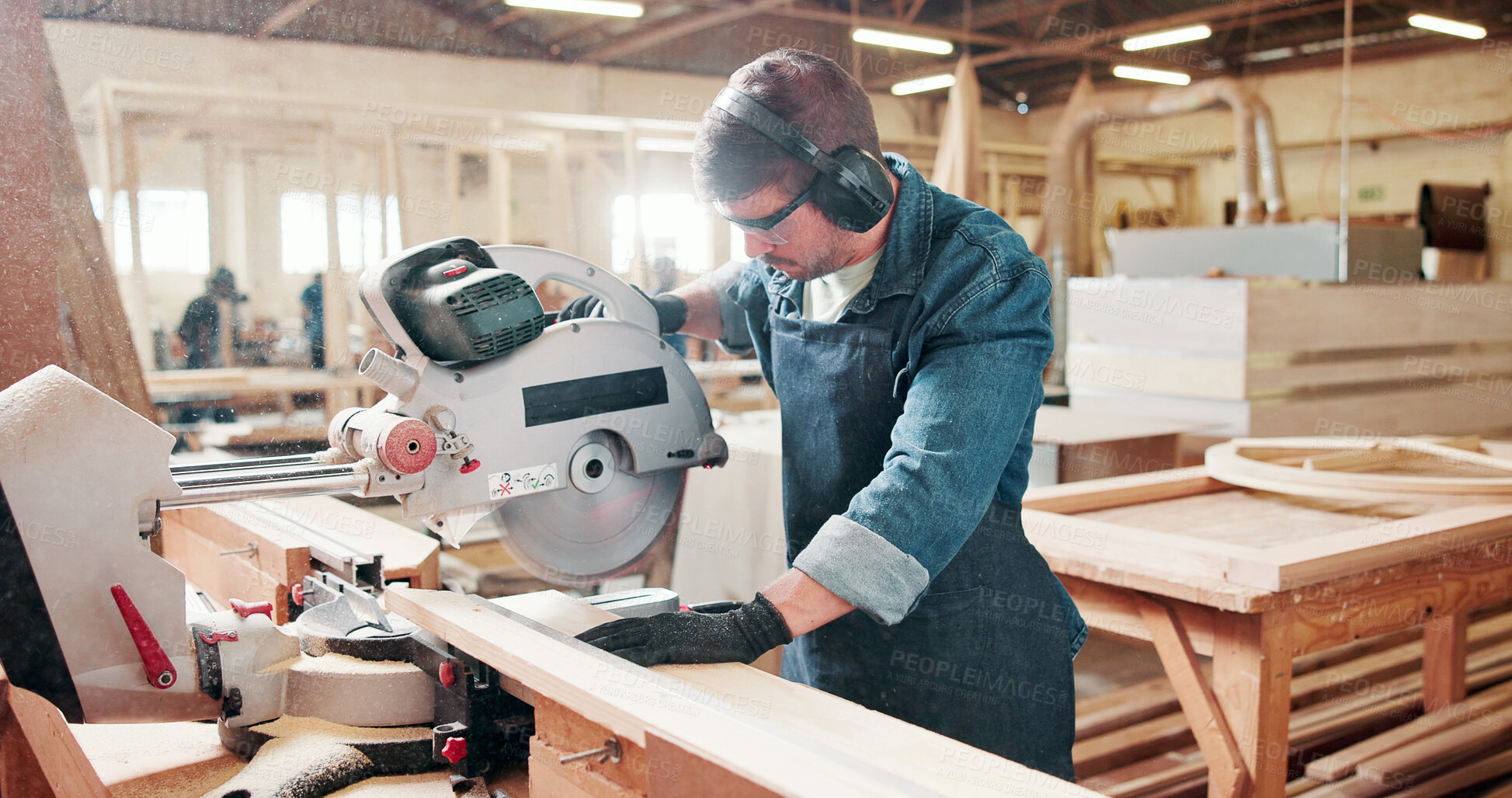 Buy stock photo Man, carpenter and miter saw for wood at warehouse with manufacturing process at industrial plant. Person, tools and technician with equipment for cutting, material and safety goggles at factory