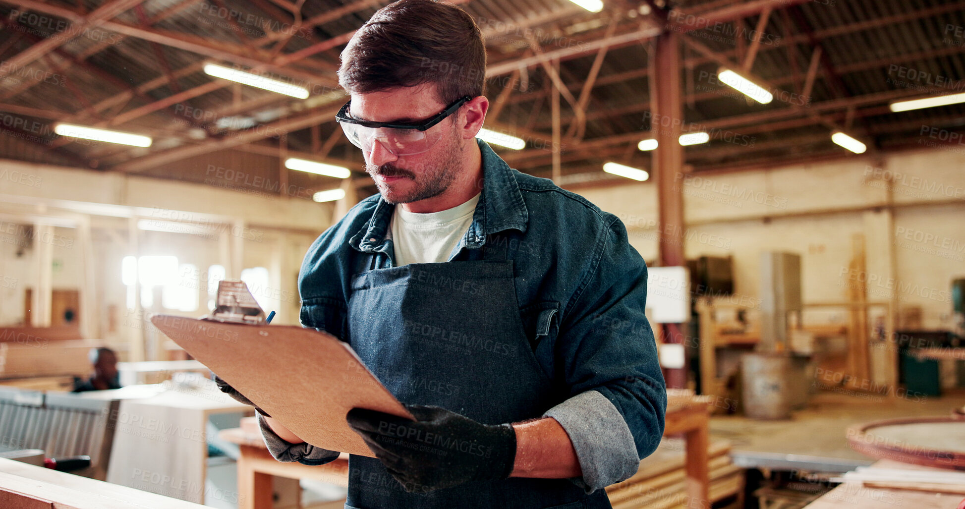 Buy stock photo Carpenter, man and inspection in workshop with clipboard, review manufacturing and building project. Person, PPE and checklist in factory with woodwork production, quality control or work evaluation.