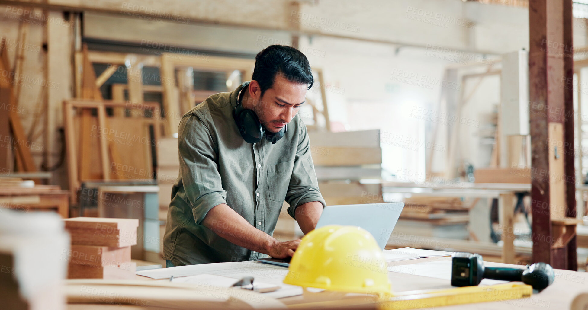 Buy stock photo Carpenter, man and typing in workshop with laptop, building project info and manufacturing research. Person, browse and reading in factory with computer, planning and website for woodwork production.