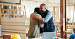Happy man, team and carpenter at factory with hug, excited and motivation for manufacturing job. People, smile and handshake with woodwork, insight and embrace for production at industrial warehouse