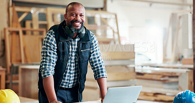 Buy stock photo Black man, carpenter and smile with laptop at factory, portrait or manufacturing at industrial plant. Mature person, technician and happy with for review, material or production at warehouse in Kenya
