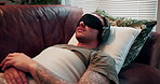 Headphones, psychology and man with blindfold on sofa, sensory deprivation and anxiety counseling. Relaxation therapy, calm and person with mindfulness training for ptsd, therapeutic audio and tech