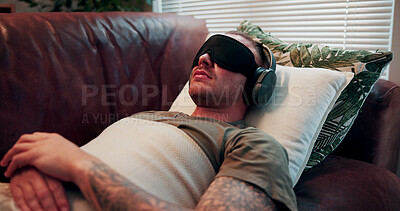 Buy stock photo Headphones, psychology and man with blindfold on sofa, sensory deprivation and anxiety counseling. Relaxation therapy, calm and person with mindfulness training for ptsd, therapeutic audio and tech