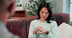 Woman, pills and healthcare on sofa for consultation, communication or question for wellness. Patient, physician and pharmaceutical discussion with medication, drugs or supplement for prescription