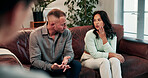 Therapy, talking and couple on sofa for session with psychologist for relationship health. People, conversation and man with woman in office with therapist for marriage advice, heal or help at clinic