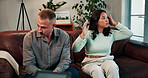 Therapy, fighting and couple on sofa for session with psychologist for relationship health. People, argument and man with woman in office with therapist for marriage advice, heal or help at clinic.