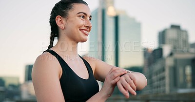 Buy stock photo Fitness, smile and watch with woman in city for progress, training or workout tracking as athlete. Buildings, exercise and time with happy runner outdoor in urban town for health or wellness activity