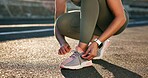 Hands, fitness and woman tie laces in city for running, workout or training for wellness outdoor. Athlete, sports and female person with sneakers preparing for cardio exercise, health or active.