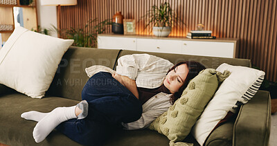 Buy stock photo Rest, menstruation and woman on couch with ibs, discomfort and stomach ache with symptoms. Health, fatigue and female person in house with cramps, endometriosis and abdominal pain for period.