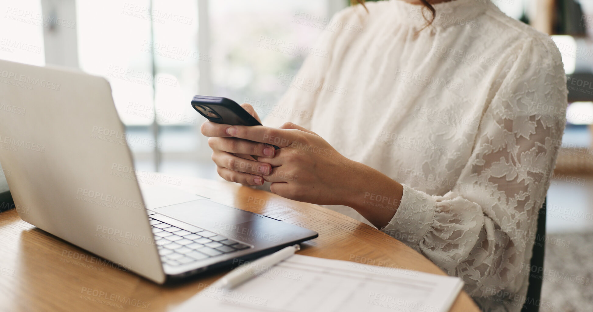 Buy stock photo Hands, phone and texting with remote work from home with laptop, documents or contact in living room. Person, smartphone and pc with typing in house, notification and administration for freelance job