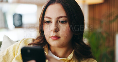 Buy stock photo Serious, woman and relax with phone at house for social media, browsing website and chatting. Female person, scroll and reading with mobile app for text message, communication and online notification