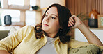 Thinking, morning and woman on sofa in home for reflection, nostalgia and daydreaming on weekend. Apartment, bored and person on couch with memory, thoughtful and wondering for planning day on break
