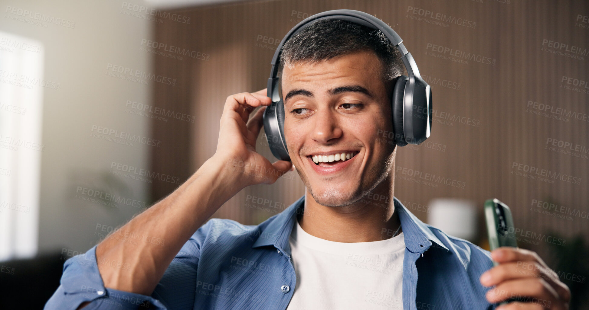 Buy stock photo Headphones, phone and man in home with remote work for creative project with listening to music. Audio tech, cellphone and male editor streaming playlist for freelance publishing in apartment.