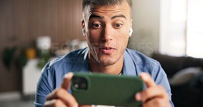 Buy stock photo Earphones, surprise or man with smartphone in home, streaming web series or attention for online show. Movie subscription, tech or person with shock for video scene, binge watching or action film