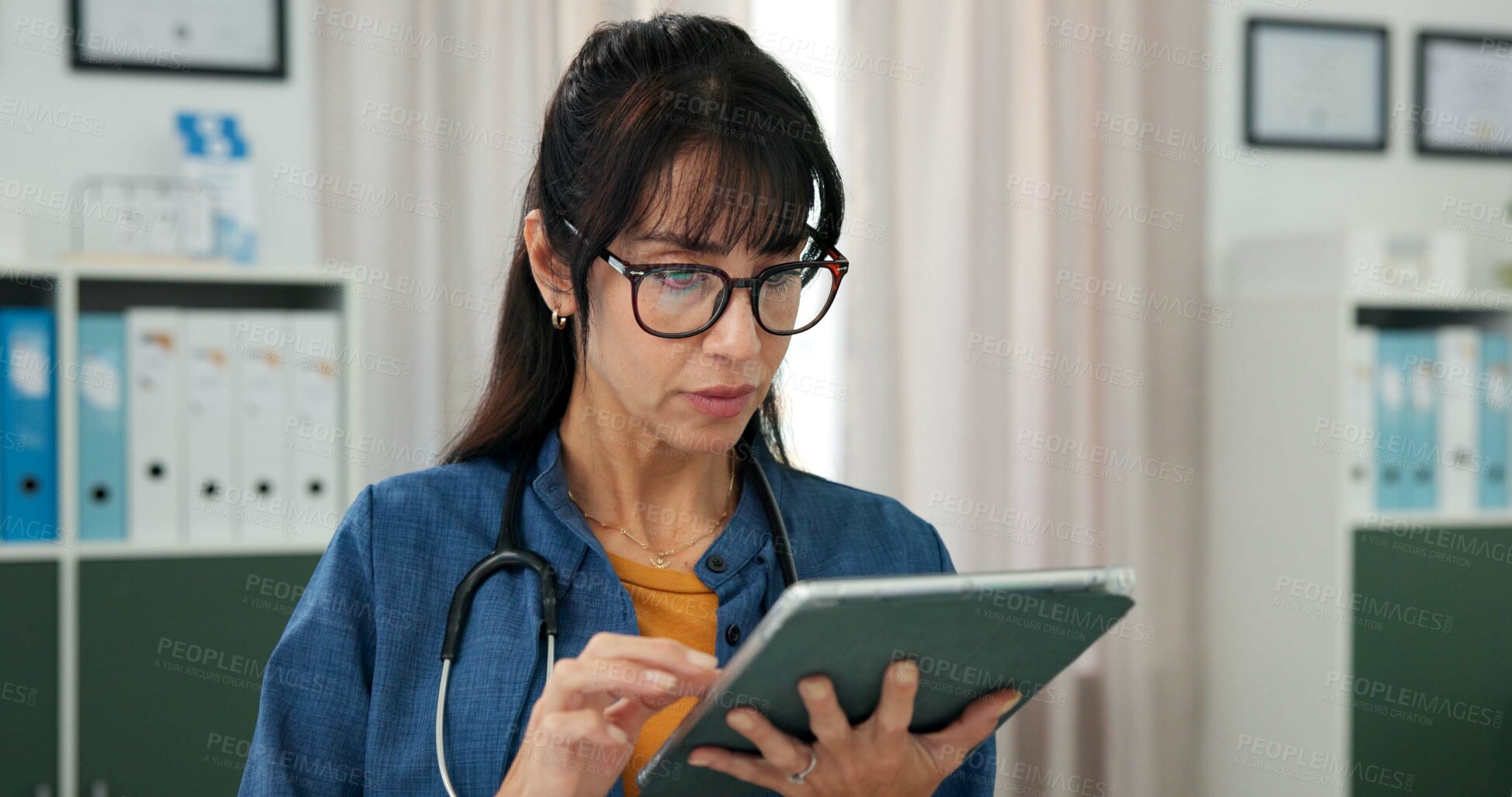Buy stock photo Doctor, woman and reading with tablet in office, virtual healthcare consulting and online prescription. Telehealth, medical resources and mature physician with diagnostic info, patient app and tech