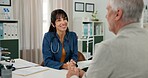 Doctor, woman and talking to old man in consultation for health advice, treatment update and chat. Hospital, mature professional and senior patient with checkup for wellness, results and healthcare