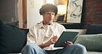 Smile, relax and man with tablet on sofa for social media post, reading and online update. Networking, newsletter subscription and connection with person in living room of home for chat and scroll