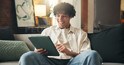 Buy stock photo Tablet, relax and man in home, smile and typing for communication, internet and message to contact. Online humor, tech and person on sofa, funny meme and digital app for social media and website info