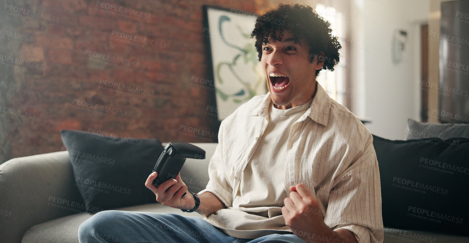 Buy stock photo Man, celebration and winner with video game on sofa in home with fist pump for next level in lounge. Person, excited and success with controller, console and virtual challenge on couch at apartment