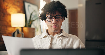 Buy stock photo Man, document and laptop in apartment with remote work, glasses or journalist proofreading for news. Freelance writer, person and paperwork in home with computer, article review and website for blog.