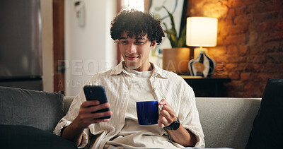Buy stock photo Coffee, smile and man on sofa with phone for social media, online message and chat in home. Weekend, relax and person on smartphone for internet, connection and notification on mobile app with drink