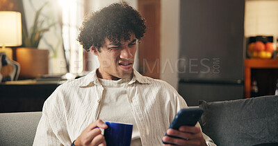 Buy stock photo Coffee, confused and man on sofa with phone for social media, online message and chat in home. Weekend, gossip and person with tech for rumor, fake news and notification on mobile app with drink