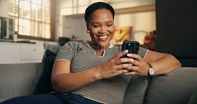 Buy stock photo Relax, woman and happy with phone on sofa for dating app, chat notification and message response. Smartphone, black person and smile in home for profile match, online conversation and weekend break