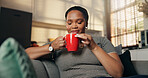 Woman, relax and smell coffee at house for peace, espresso aroma and calm morning in lounge. Smile, female person and inhale beverage for caffeine scent, enjoy fragrance and nostalgia memory on couch