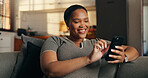 Relax, woman and scroll with phone in home for dating app, chat notification and message response. Happy, black person or swipe on mobile on sofa for profile match, online connection or weekend break