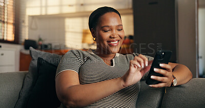 Buy stock photo Relax, woman and scroll with phone in home for dating app, chat notification and message response. Happy, black person or swipe on mobile on sofa for profile match, online connection or weekend break
