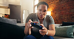 Black woman, gamer and excited with smile on sofa for esport, challenge or tournament in home. Female person, player or gaming with streaming, controller or competition on couch for contest in house