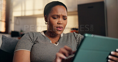 Buy stock photo Confused, gossip and black woman with tablet on sofa for shock, online message and chat in home. Surprise, social media and person with tech for rumor, fake news and negative notification on app