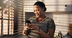 Smile, woman and typing with phone in home for texting, chat notification or message response. Happy, black person or smartphone in kitchen for social media post, online conversation or weekend break