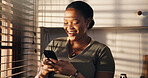 Typing, woman and laugh with phone in home for dating app, funny notification and profile match. Happy, black person and smartphone in kitchen for social media meme, message response and online joke