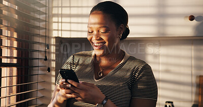 Buy stock photo Typing, woman and laugh with phone in home for dating app, funny notification and profile match. Happy, black person and smartphone in kitchen for social media meme, message response and online joke