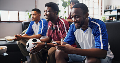 Buy stock photo Men, phone and friends on couch for soccer game, watching tv or distracted with texting in home. Group, stop typing and smartphone with talk, smile or chat on mobile app with football fans at house
