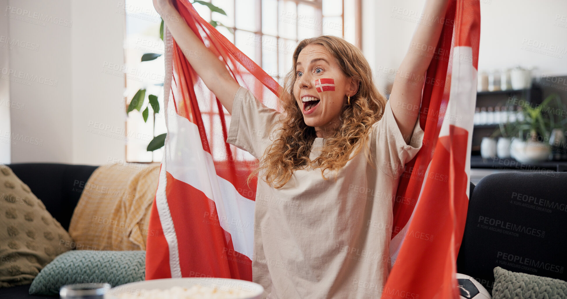 Buy stock photo Woman, Denmark flag and celebration in home, soccer and cheering for game, shouting and winning. Fan, screaming and person in lounge, football and excited for score lead, expression or supporter