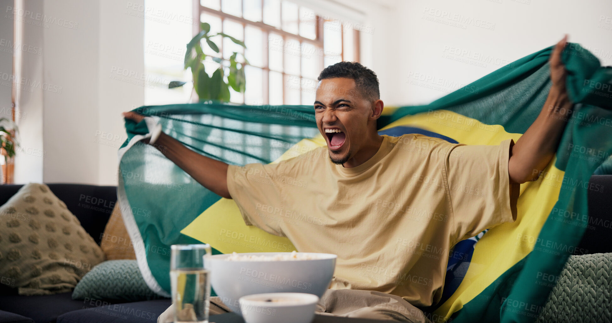 Buy stock photo Man, Brazil flag and celebration in home, soccer and excited for champion, shouting and winning. Fan, cheering and person in lounge, football and screaming for score lead, tournament or supporter