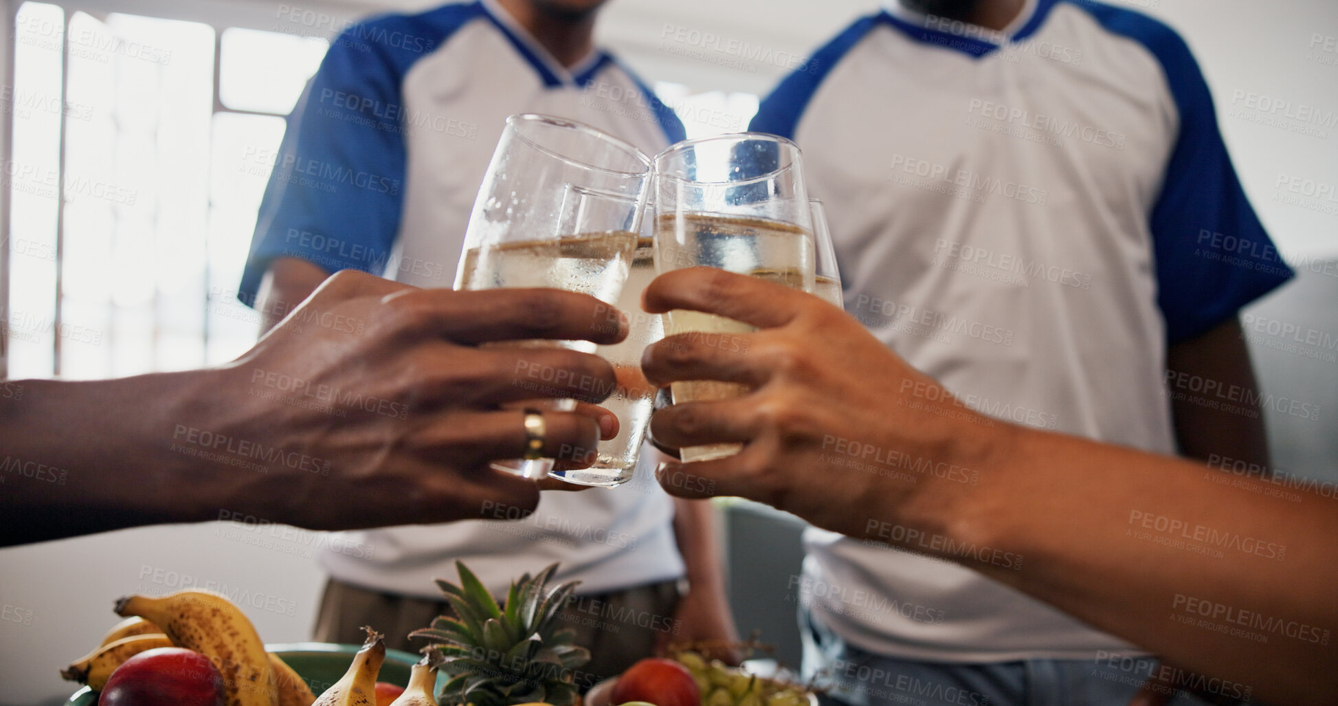 Buy stock photo Hands, friends and toast with drinks in home for celebration, reunion or party with football shirt for game. People, group and glasses with beverage, alcohol or bonding for sports tournament at house