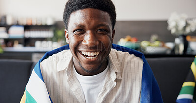 Buy stock photo Man, excited and South Africa flag for soccer on couch with pride, happy and support team in home. African person, smile and portrait on sofa, streaming and global football competition at apartment