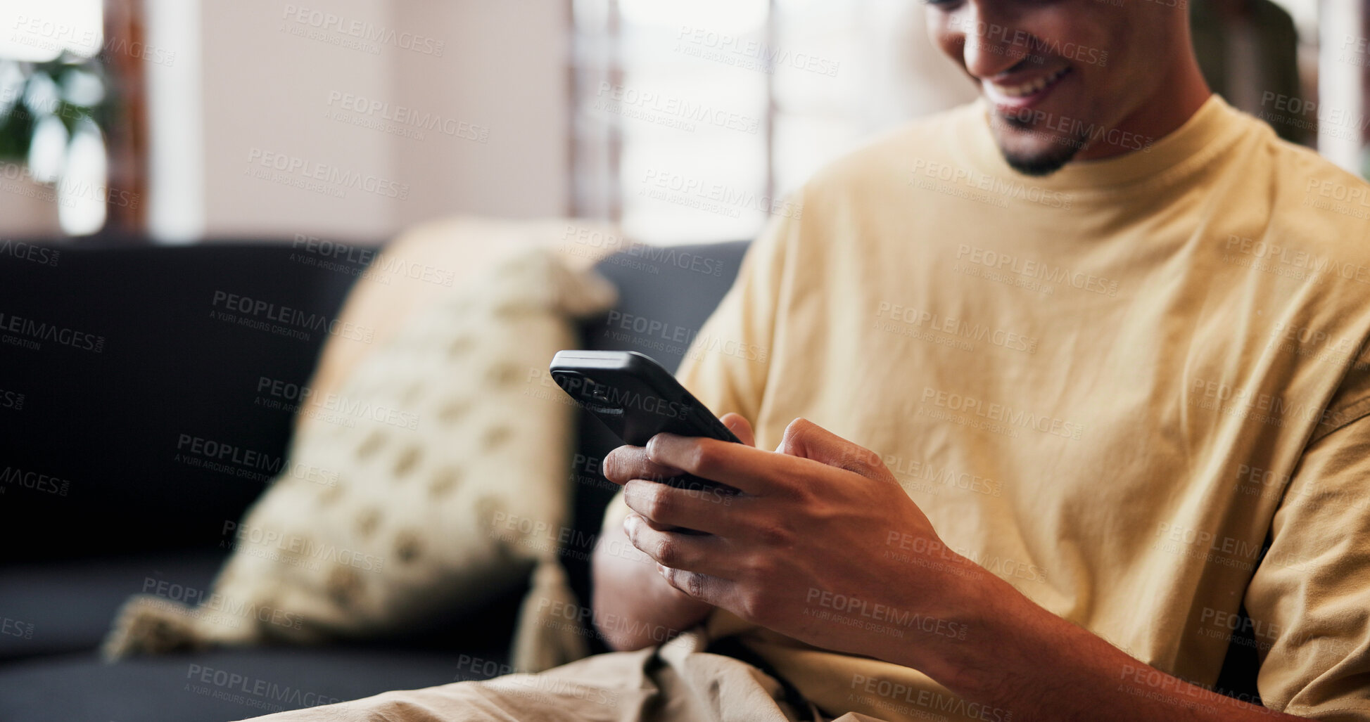 Buy stock photo Smile, reading and hands with phone on couch, check social media notification and watch online video. Digital communication, typing and man with mobile in home for message, blog and browsing internet