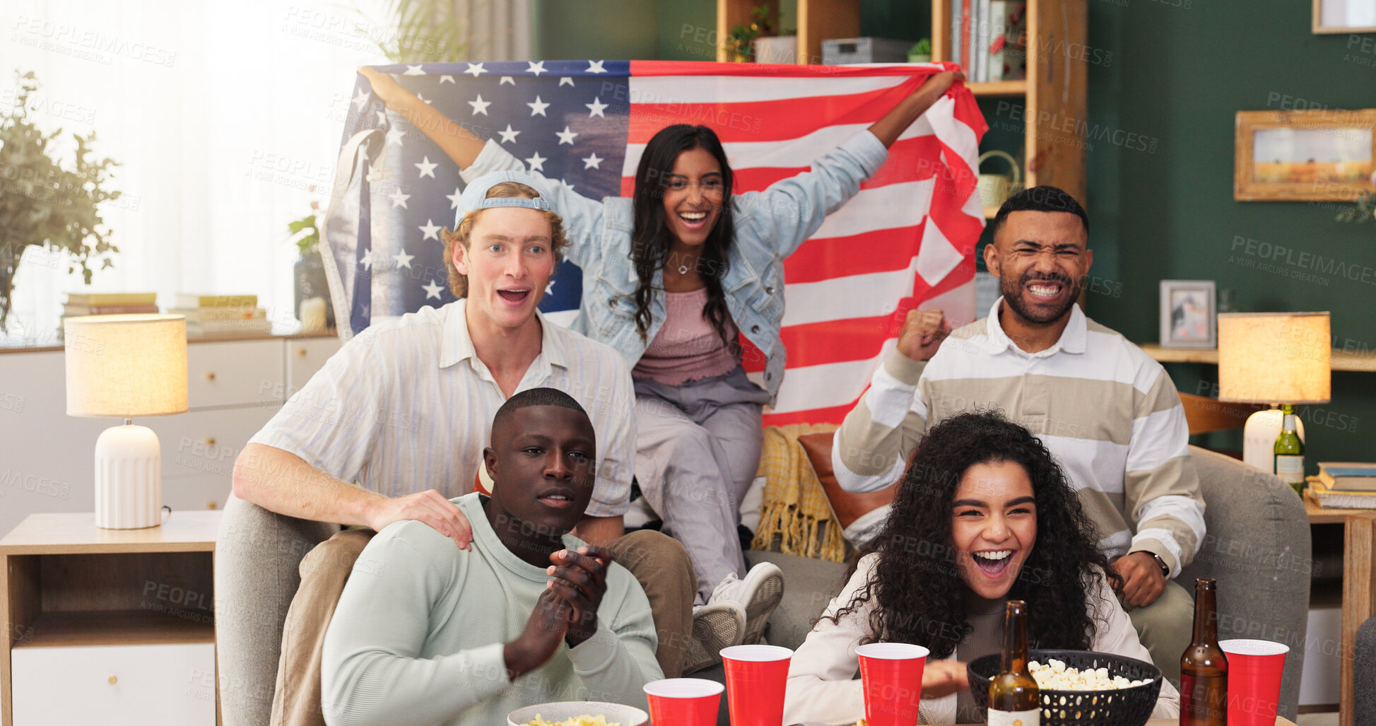 Buy stock photo Excited, fans and people with American flag in lounge, watching tv or happiness for football success. Group, together and friends with alcohol for live stream, home and celebration for sport match