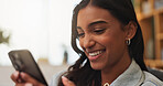 Happy woman, reading and chatting with phone in home for social media, gossip or conversation. Female person, user or smile with mobile smartphone for online texting, network service or communication